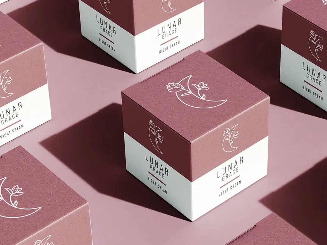 Grid of mauve and white Lunar Grace product boxes with the crescent-moon-and-bloom line mark.