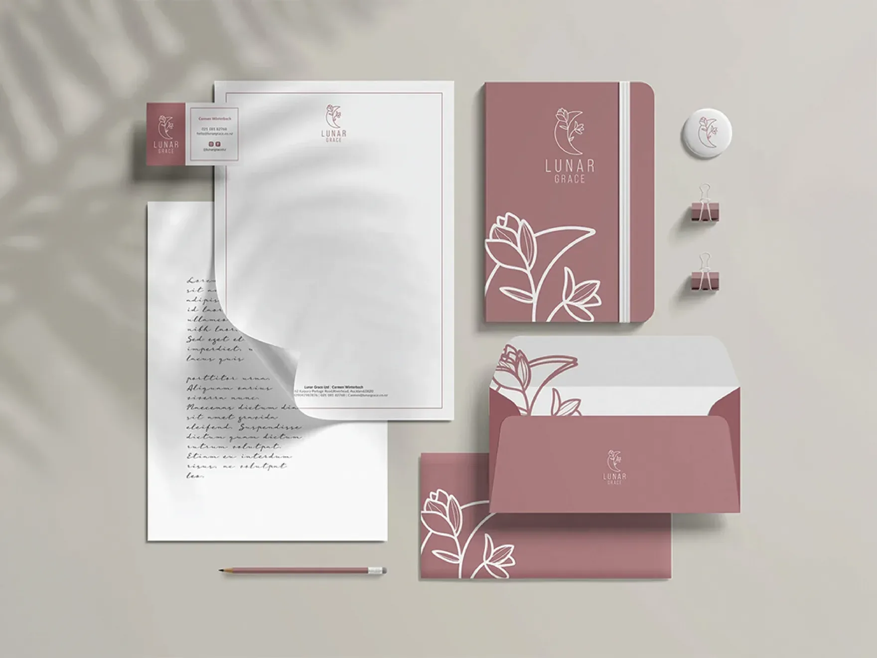 Lunar Grace stationery set: letterhead, notebook, envelopes and business cards in mauve and white.